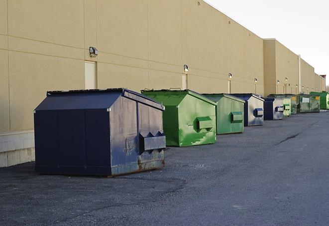 a construction worker moves construction materials near a dumpster in East Rutherford, NJ